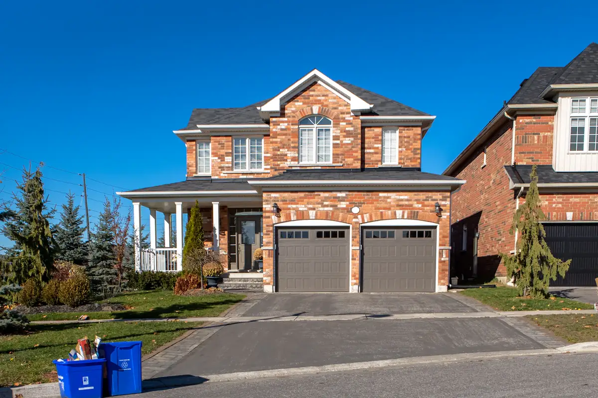A house with an attached garage under a clear sky