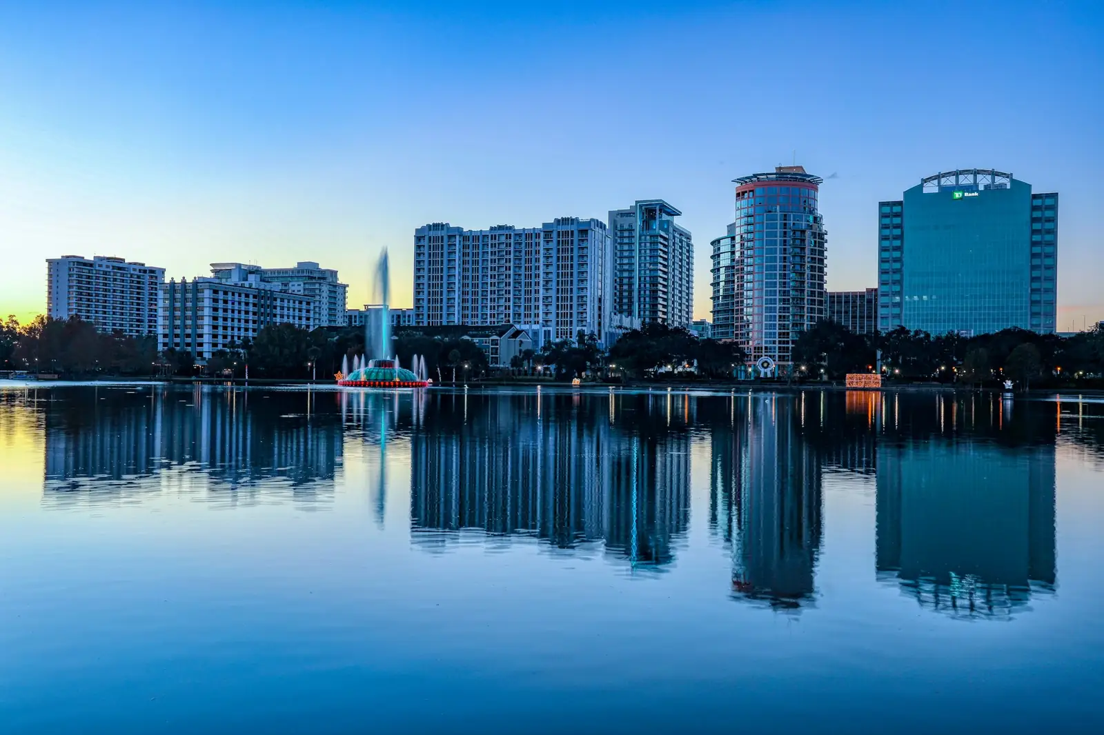 The downtown Orlando skyline and fountain reflected in Lake Eola at dawn